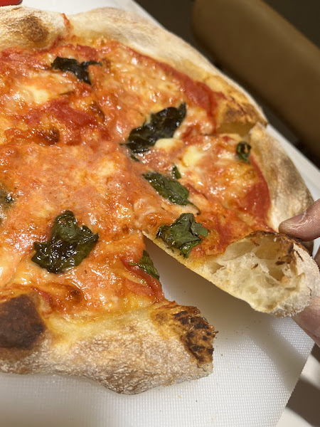 Close-up of TomatoPapi Margherita pizza with fresh basil