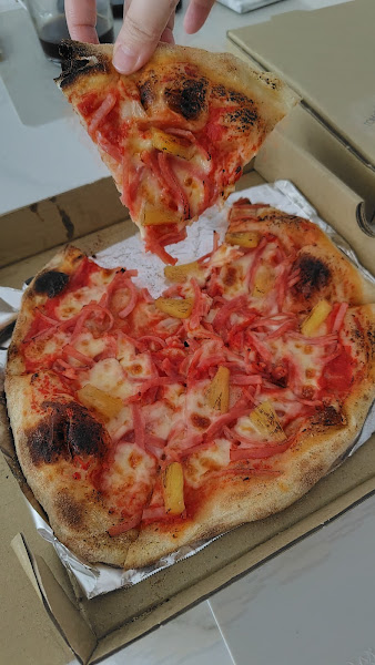 Hawaiian pizza slice pull from TomatoPapi showing ham and pineapple